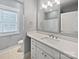 Bright bathroom features a white vanity with marble countertop, large mirror, modern lighting, and tile floor at 1210 Aragon Beach Rd, Rock Hill, SC 29732