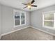 Neutral bedroom with two windows and carpeted floors at 1210 Aragon Beach Rd, Rock Hill, SC 29732