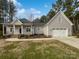 Charming one-story home with a gray exterior, a well-kept lawn, and a two-car garage at 1210 Aragon Beach Rd, Rock Hill, SC 29732