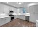Modern kitchen featuring white cabinets, quartz countertops, stainless steel appliances, and hardwood floors at 1210 Aragon Beach Rd, Rock Hill, SC 29732