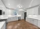 Bright kitchen featuring white cabinets, stainless steel appliances, and wood floors, great for cooking and entertaining at 1210 Aragon Beach Rd, Rock Hill, SC 29732
