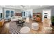 Bright living room with hardwood floors, modern furniture, and a view into the dining area at 1210 Aragon Beach Rd, Rock Hill, SC 29732