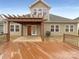 Beautiful backyard featuring a pergola, wooden deck and manicured lawn at 13217 Reunion St, Charlotte, NC 28278