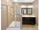 Clean bathroom featuring a glass shower, tiled walls, and a double sink vanity at 13217 Reunion St, Charlotte, NC 28278