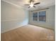 Cozy bedroom featuring neutral walls, carpet, and a large window for natural light at 13217 Reunion St, Charlotte, NC 28278