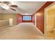 Large bonus room with neutral carpet, many windows, and an adjacent full bathroom at 13217 Reunion St, Charlotte, NC 28278