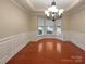 Formal dining room featuring natural light, detailed trim work, and hardwood floors at 13217 Reunion St, Charlotte, NC 28278