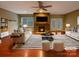 Bright living room featuring a stone fireplace, ceiling fan, and stylish furniture at 13217 Reunion St, Charlotte, NC 28278