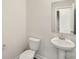 Half-bathroom featuring a pedestal sink, toilet, and a neutral color scheme at 138 Aberdeen Dr, Salisbury, NC 28144