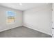 A bright bedroom features neutral carpet, a large window, and fresh paint at 138 Aberdeen Dr, Salisbury, NC 28144