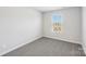 A cozy bedroom features neutral carpet, a bright window, and fresh paint at 138 Aberdeen Dr, Salisbury, NC 28144