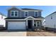 Charming two-story home with a stone facade, a two-car garage, and classic architectural details at 138 Aberdeen Dr, Salisbury, NC 28144