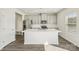 Bright kitchen features a large island, stainless steel appliances, modern gray cabinets, and wood floors at 138 Aberdeen Dr, Salisbury, NC 28144