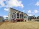 The backyard features a screened in porch on a well maintained lawn at 144 Tetcott St, Mooresville, NC 28115