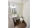 Cozy powder room with a pedestal sink, modern lighting, and wood-look flooring at 144 Tetcott St, Mooresville, NC 28115