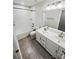 Stylish bathroom with double sinks, a soaking tub/shower combination and modern fixtures at 144 Tetcott St, Mooresville, NC 28115