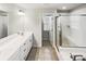 Contemporary bathroom featuring a double vanity, glass-enclosed shower, and ample counter space at 144 Tetcott St, Mooresville, NC 28115