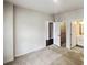 Bright bedroom with neutral carpet, leading to a walk-in closet and bathroom with a white vanity at 144 Tetcott St, Mooresville, NC 28115