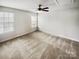 Bright bedroom with large windows offering natural light and plush carpeting at 144 Tetcott St, Mooresville, NC 28115