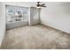 Neutral bedroom with large windows offering natural light and ceiling fan at 144 Tetcott St, Mooresville, NC 28115