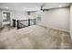 Spacious upstairs bonus room with plush carpeting and a modern ceiling fan at 144 Tetcott St, Mooresville, NC 28115