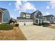 Charming two-story home with a three car garage, well-manicured landscaping, and a large driveway at 144 Tetcott St, Mooresville, NC 28115