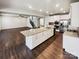 Open-concept kitchen with a large center island, stainless steel appliances, and white cabinets at 144 Tetcott St, Mooresville, NC 28115