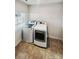 Convenient laundry room featuring a washer, a dryer, and a window for natural light at 144 Tetcott St, Mooresville, NC 28115