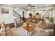 Bright, open-concept living space with hardwood floors, neutral decor and an inviting staircase at 144 Tetcott St, Mooresville, NC 28115