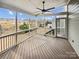 Relaxing screened porch with a ceiling fan, views of the backyard, and wood floors at 144 Tetcott St, Mooresville, NC 28115