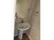 Small powder room featuring a pedestal sink, mirror, and simple wall decor at 15200 Chowning Tavern Ln, Charlotte, NC 28262