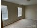 Bedroom with two windows and carpet at 15200 Chowning Tavern Ln, Charlotte, NC 28262