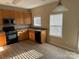 Functional kitchen with stainless steel appliances, ample counter space, and wooden cabinets at 15200 Chowning Tavern Ln, Charlotte, NC 28262