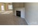Cozy living room with a fireplace and carpeted floors at 15200 Chowning Tavern Ln, Charlotte, NC 28262