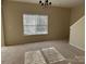 Carpeted living room with a window and a chandelier at 15200 Chowning Tavern Ln, Charlotte, NC 28262