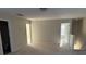 Spacious, carpeted living room with multiple doorways and ample natural light at 15200 Chowning Tavern Ln, Charlotte, NC 28262