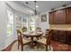 Breakfast nook with wood table, seating for four, and natural light from bay window at 15323 Prescott Hill Ave, Charlotte, NC 28277