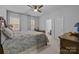 Spacious bedroom featuring an ensuite bathroom, a ceiling fan, and natural light from the windows at 15323 Prescott Hill Ave, Charlotte, NC 28277