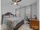 Bright bedroom featuring a ceiling fan, two windows providing natural light, and a functional desk area at 15323 Prescott Hill Ave, Charlotte, NC 28277