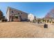 Spacious backyard featuring a custom outdoor kitchen and an outdoor seating area at 16110 Foreleigh Rd, Huntersville, NC 28078