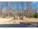 Backyard featuring a brick patio with a fire pit, perfect for gatherings and relaxation at 16110 Foreleigh Rd, Huntersville, NC 28078