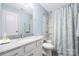 Well-lit bathroom with vanity, granite countertop, and shower-tub combo at 16110 Foreleigh Rd, Huntersville, NC 28078