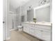 Bright bathroom with a double vanity, glass shower, and neutral tile flooring at 16110 Foreleigh Rd, Huntersville, NC 28078
