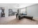 Large bonus room has cozy sitting area with carpet flooring and a modern chandelier at 16110 Foreleigh Rd, Huntersville, NC 28078
