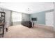 Spacious bonus room with tv, workstation, carpet flooring, and modern chandelier at 16110 Foreleigh Rd, Huntersville, NC 28078