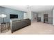 Bright bonus room with neutral walls, a gray sofa and a stylish light fixture at 16110 Foreleigh Rd, Huntersville, NC 28078