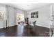 Dining area featuring a glass table, white chairs, and a view of the outdoor patio at 16110 Foreleigh Rd, Huntersville, NC 28078