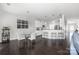 Dining area featuring a glass table, white chairs, and a stylish bar cart at 16110 Foreleigh Rd, Huntersville, NC 28078