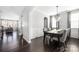 Dining room with dark hardwood floors, elegant chandelier and view to the living room at 16110 Foreleigh Rd, Huntersville, NC 28078