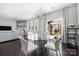 Dining area featuring a glass table, white chairs, and a view of the outdoor patio and grill at 16110 Foreleigh Rd, Huntersville, NC 28078